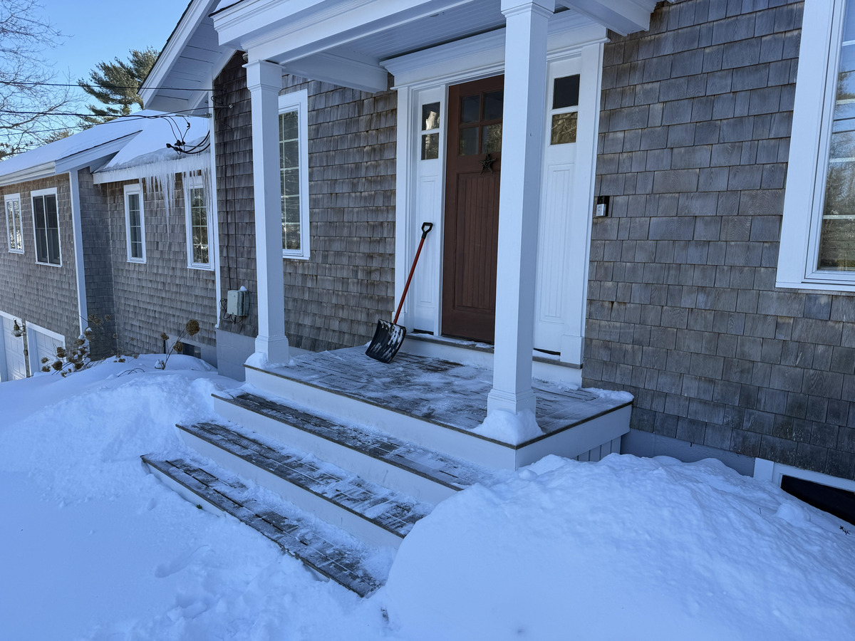 Cedar shake siding with snow-covered porch in Duxbury