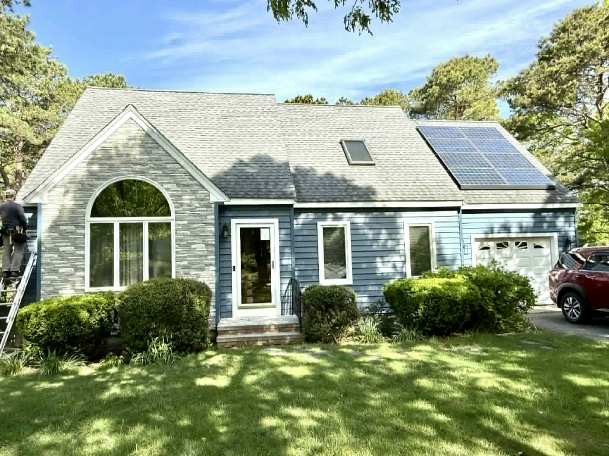 Cape Cod home with new gray siding and stone accent
