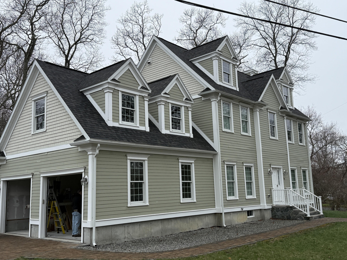 Large colonial home with new clapboard siding installed by Model Home Renovations in Marshfield MA