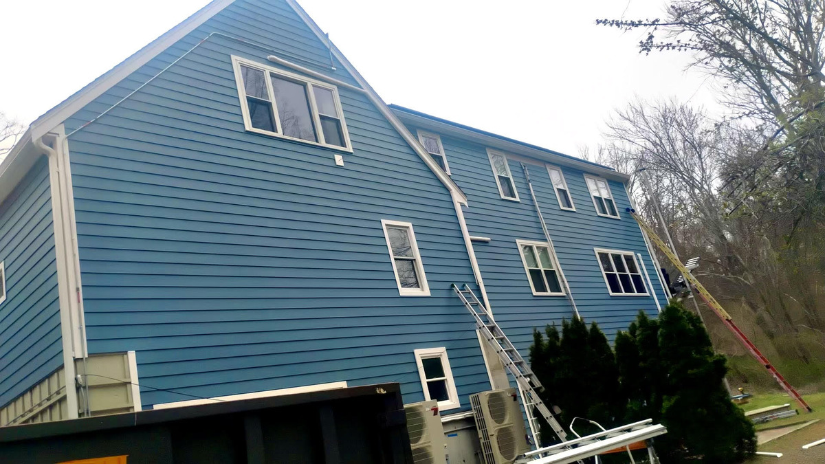 Blue clapboard siding installation on a Marshfield home