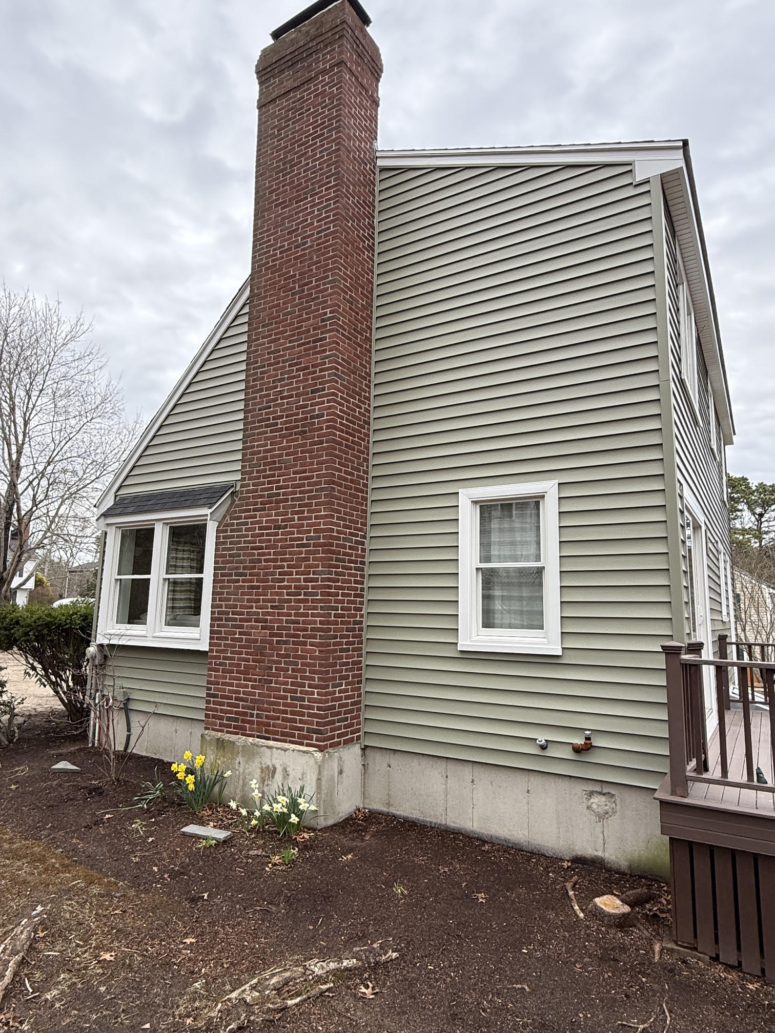 Home with new siding and chimney detail in Plymouth