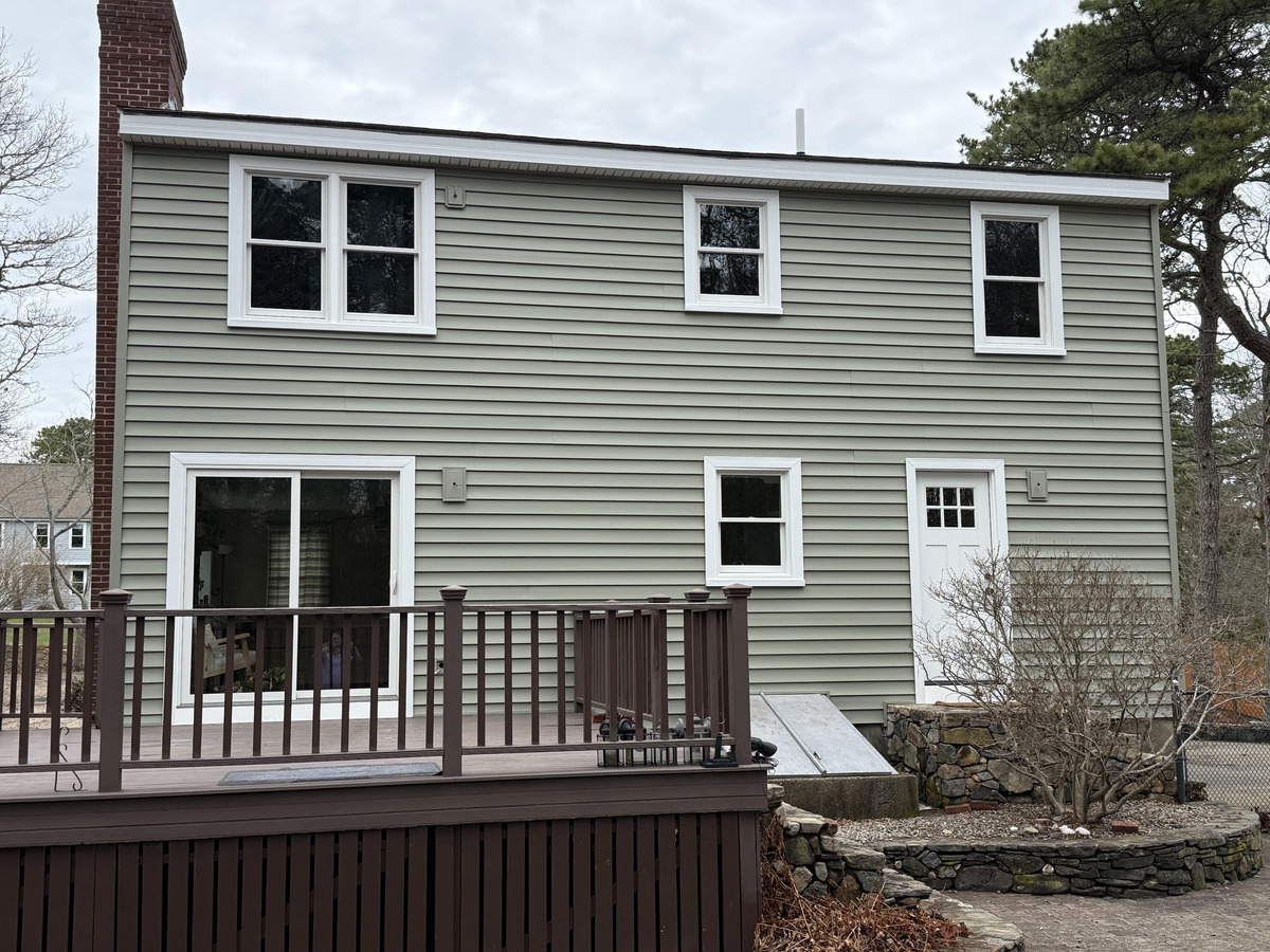 Rear view of a Plymouth home with new sage green siding