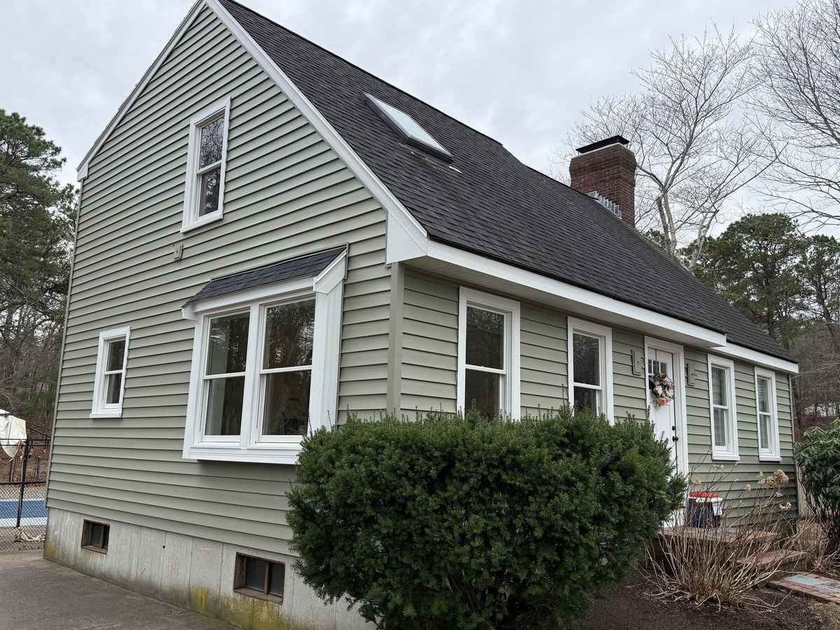 Side elevation showing new siding and windows in Plymouth